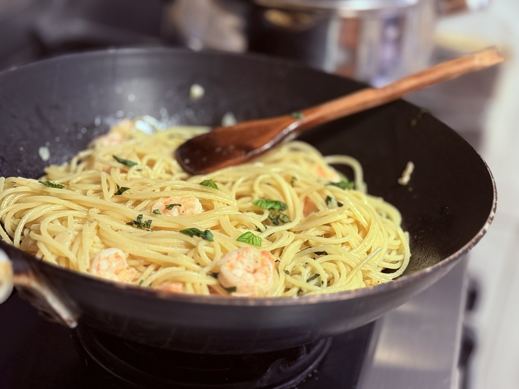 Spaghetti being prepared in a frying pan